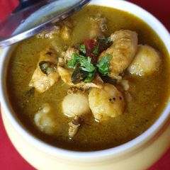 A picture of Malabar Kozhi Pidi (rice dumplings in soupy chicken curry).