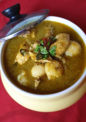 A picture of Malabar Kozhi Pidi (rice dumplings in soupy chicken curry).