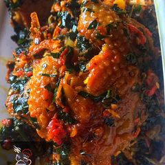 A picture of Ettas native chicken stew with ugu leaf.