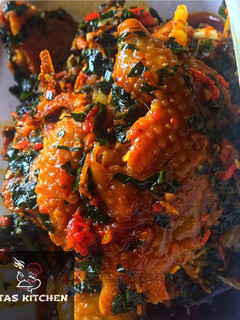 A picture of Ettas native chicken stew with ugu leaf.