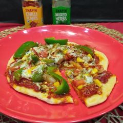 A picture of Cheesy crust veg Pizza in tawa.