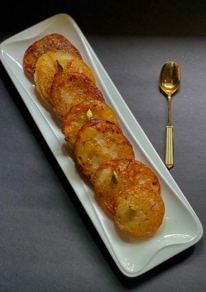 A picture of Ranga Aloo or Misti Aloo Malpua / Sweet Potato Malpua.