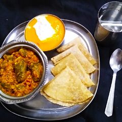 Stuff Bitter Gourd With mango ras and padya Roti A picture of Stuff Bitter Gourd With mango ras and padya Roti.