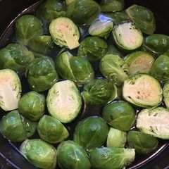 A picture of California Farm Black Garlic Poached Brussels Sprouts.