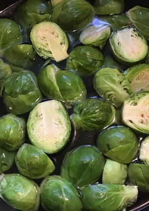 A picture of California Farm Black Garlic Poached Brussels Sprouts.