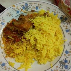 A picture of Turmeric rice and chicken stew.