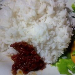 A picture of Boiled rice and African nutmeg stew.