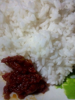 A picture of Boiled rice and African nutmeg stew.
