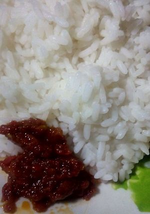 A picture of Boiled rice and African nutmeg stew.