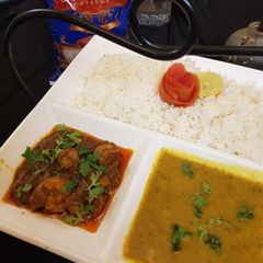 A picture of Garlic rice with daal chawal and prawn curry.