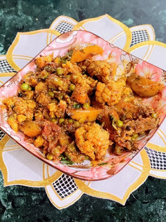 A picture of Aloo Gobhi Matar/ Potato Cauliflower Green Peas Dry Curry.