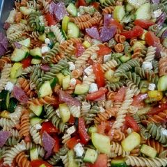 A picture of Pasta salad with feta cheese and salami.