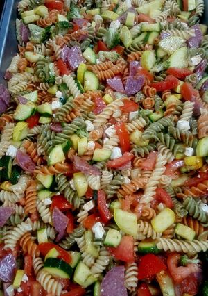 A picture of Pasta salad with feta cheese and salami.