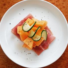 A picture of Cantaloupe Melon With Prosciutto And Cucumber.