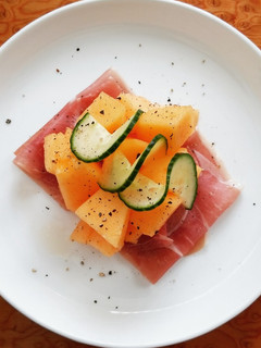 A picture of Cantaloupe Melon With Prosciutto And Cucumber.