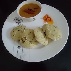 A picture of Rava Idli with Sambar and podi.