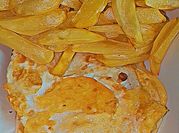 A picture of irish potatoes chips and fried egg