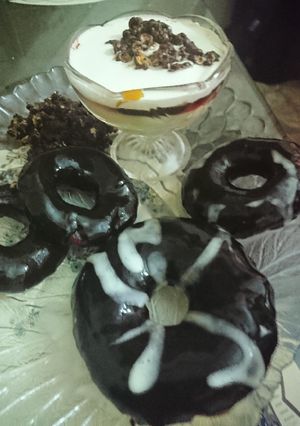 A picture of Chocolate Donuts filled with custard.