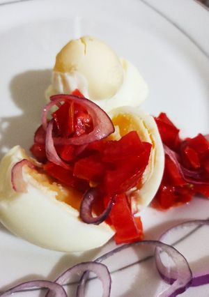 A picture of Boiled eggs with kachumbari.