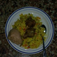 A picture of Fried rice, moi-moi and chicken.