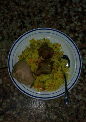 A picture of Fried rice, moi-moi and chicken.