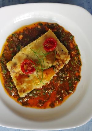 A picture of Frittatas in Chimichurri sauce.