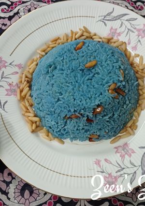 A picture of Blue Ghee Rice with Pine nuts.