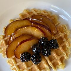 A picture of Waffles with fruit and honey.
