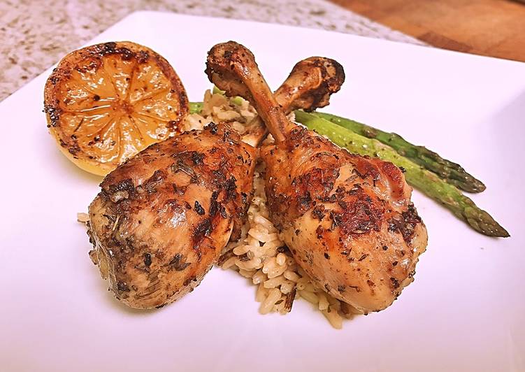 French cut grilled lemon pepper drums with wild rice and asparagus