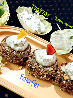 A picture of Falafel-Salsa-Baba ghanoush-Tzatziki-Salad.