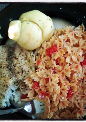 A picture of baked tilapia and tomatoe basil pasta.