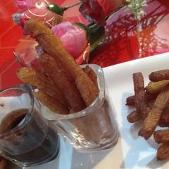 A picture of Churros with chocolate dip.