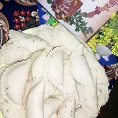 A picture of Frozen chicken samosy D shape.