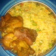 A picture of Fried rice and chicken.