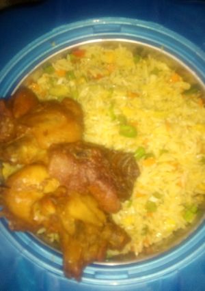 A picture of Fried rice and chicken.