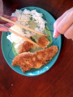 A picture of fried fish and cabbage rice.