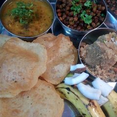 Poori,aloo veg,halva(rava),chana,(ramnavmi special kanjak bhog) A picture of Poori,aloo veg,halva(rava),chana,(ramnavmi special kanjak bhog).