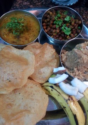 A picture of Poori,aloo veg,halva(rava),chana,(ramnavmi special kanjak bhog).