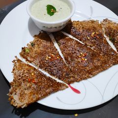 A picture of Ragi onion rava dosa with hotel style coconut chutney.