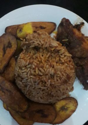 A picture of Jellof rice, plantain and chicken.
