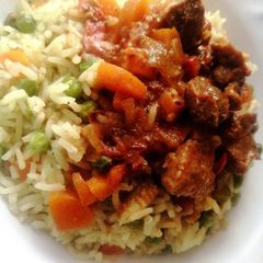 A picture of Wet fry goat meat with vegetable rice.