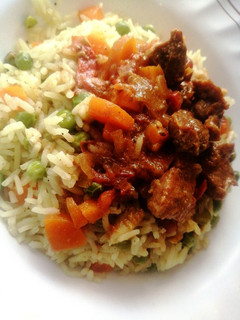 A picture of Wet fry goat meat with vegetable rice.