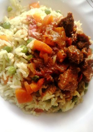 A picture of Wet fry goat meat with vegetable rice.