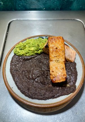 A picture of Salmon, Guacamole 🥑, and Refried Black Beans with Lard.