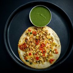 A picture of Oats uttapam with chatpata sprouts topping.