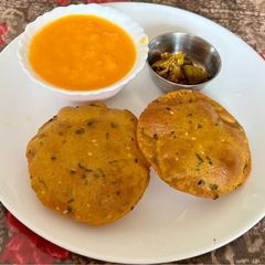 A picture of Soya flour Masala Poori With Aamras & Pickle.