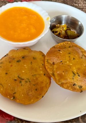A picture of Soya flour Masala Poori With Aamras & Pickle.