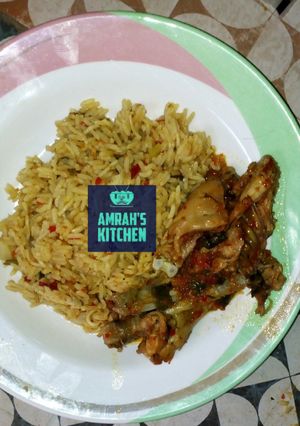A picture of Jollof rice with pepperd chicken.