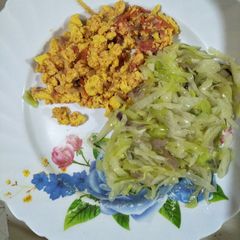 A picture of Fried cabbage with eggs.