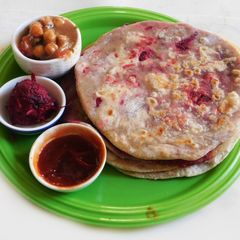 A picture of A lunch to kill for--  Beetroot masala Parantha with chickpea beetroot masala curry.